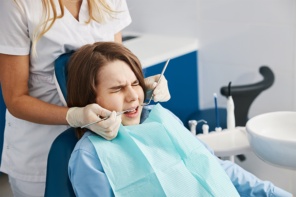 Fearful child is squinting during dental procedure